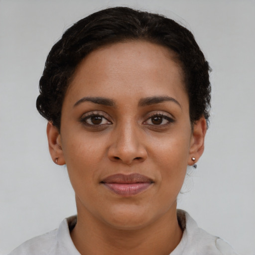 Joyful latino young-adult female with short  brown hair and brown eyes