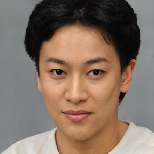 Joyful asian young-adult female with short  brown hair and brown eyes
