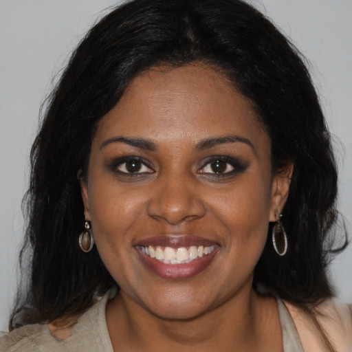 Joyful black young-adult female with medium  black hair and brown eyes