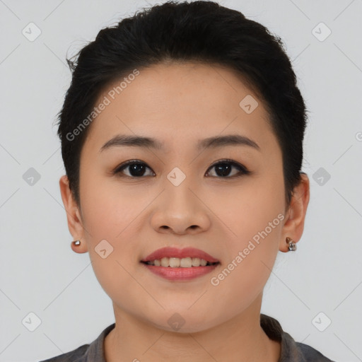 Joyful asian young-adult female with short  black hair and brown eyes