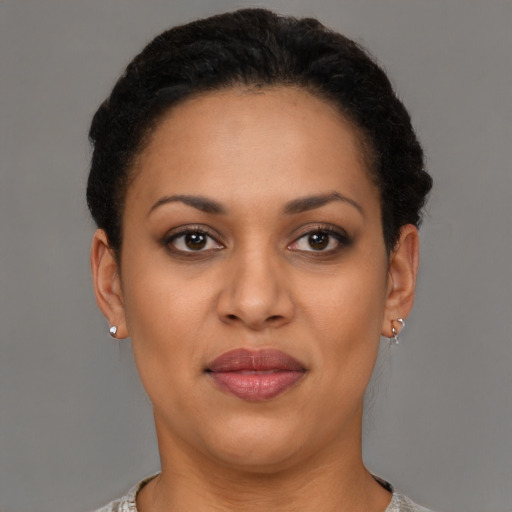 Joyful latino young-adult female with short  brown hair and brown eyes