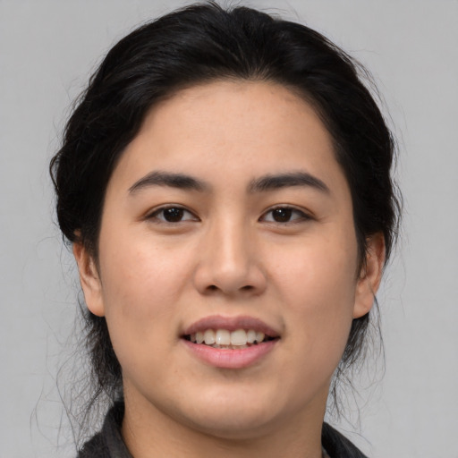 Joyful asian young-adult female with medium  black hair and brown eyes