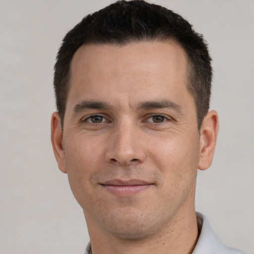 Joyful white young-adult male with short  brown hair and brown eyes