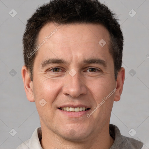 Joyful white adult male with short  brown hair and brown eyes