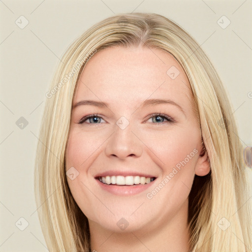 Joyful white young-adult female with long  brown hair and blue eyes