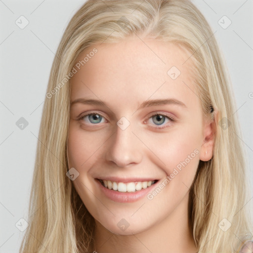 Joyful white young-adult female with long  brown hair and blue eyes