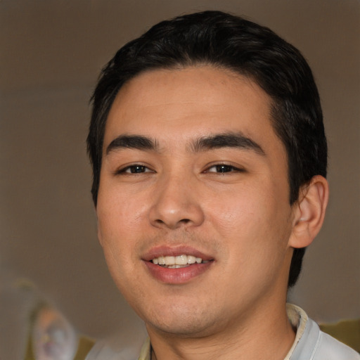 Joyful asian young-adult male with short  black hair and brown eyes