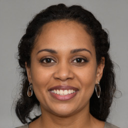 Joyful latino young-adult female with medium  brown hair and brown eyes