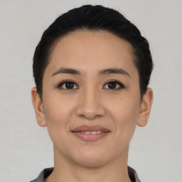 Joyful asian young-adult female with short  black hair and brown eyes