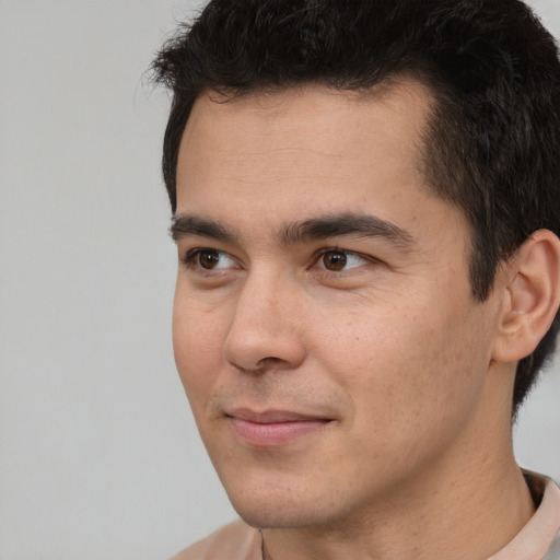 Joyful asian young-adult male with short  brown hair and brown eyes
