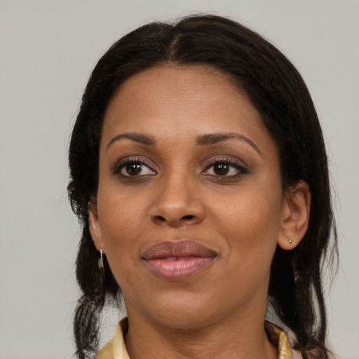 Joyful latino adult female with medium  brown hair and brown eyes