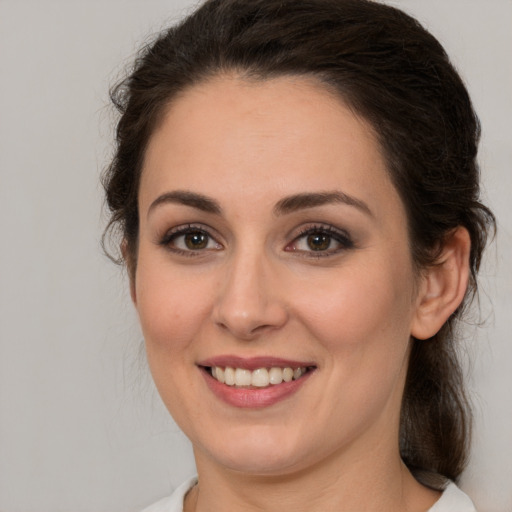 Joyful white young-adult female with medium  brown hair and brown eyes