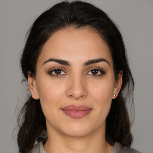 Joyful latino young-adult female with medium  brown hair and brown eyes