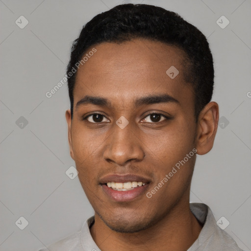 Joyful black young-adult male with short  black hair and brown eyes