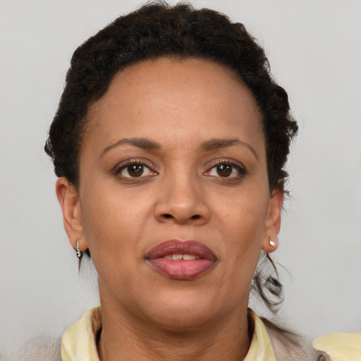 Joyful black adult female with short  brown hair and brown eyes