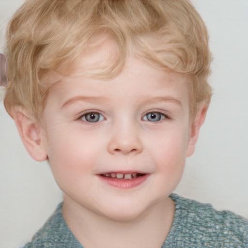 Joyful white child male with short  blond hair and blue eyes