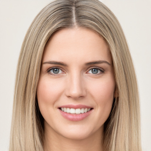 Joyful white young-adult female with long  brown hair and green eyes