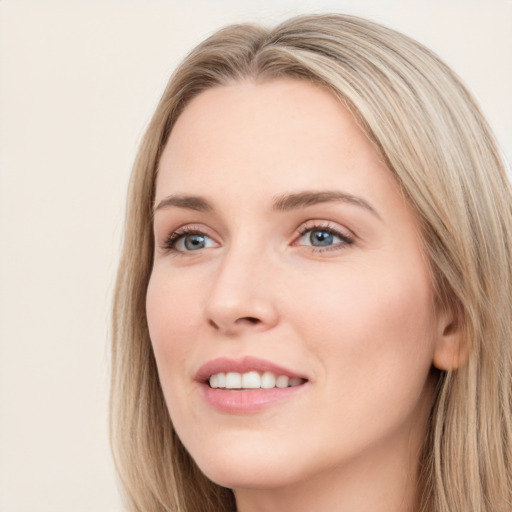 Joyful white young-adult female with long  brown hair and grey eyes