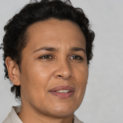 Joyful latino adult female with short  brown hair and brown eyes