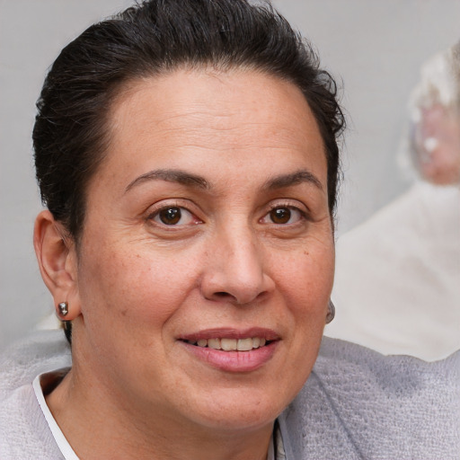 Joyful white adult female with short  brown hair and brown eyes