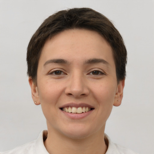 Joyful white young-adult female with short  brown hair and brown eyes