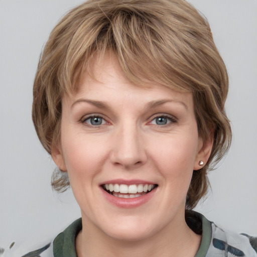 Joyful white young-adult female with medium  brown hair and blue eyes