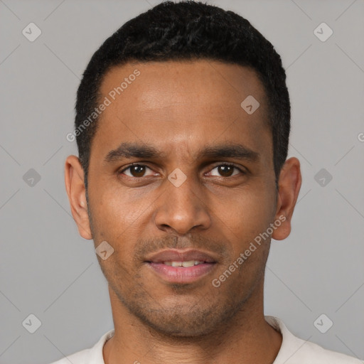 Joyful black young-adult male with short  brown hair and brown eyes