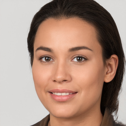 Joyful white young-adult female with long  brown hair and brown eyes