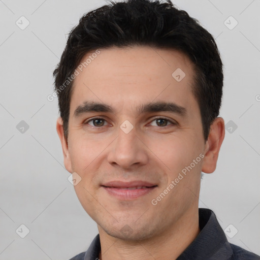 Joyful white young-adult male with short  black hair and brown eyes