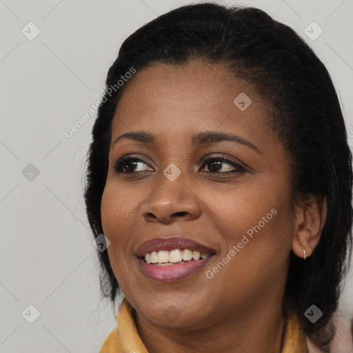 Joyful black young-adult female with long  brown hair and brown eyes