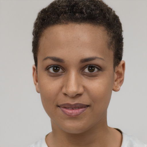 Joyful black young-adult female with short  brown hair and brown eyes