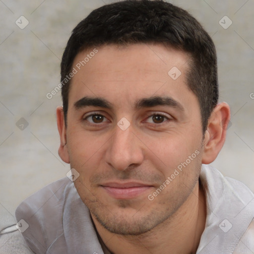 Joyful white young-adult male with short  black hair and brown eyes