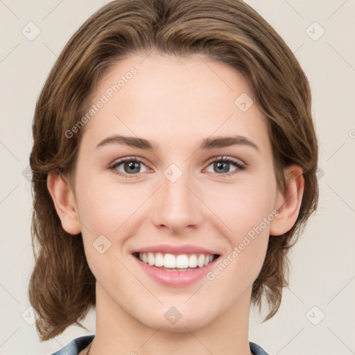 Joyful white young-adult female with medium  brown hair and green eyes