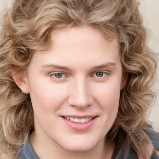 Joyful white young-adult female with medium  brown hair and blue eyes