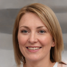 Joyful white adult female with medium  brown hair and grey eyes