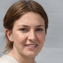 Joyful white young-adult female with medium  brown hair and grey eyes