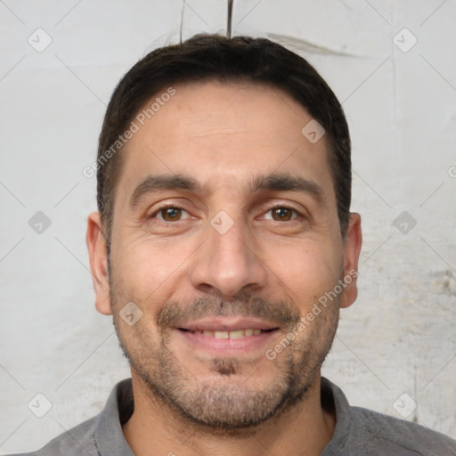 Joyful white adult male with short  brown hair and brown eyes