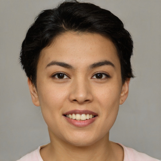 Joyful asian young-adult female with short  brown hair and brown eyes