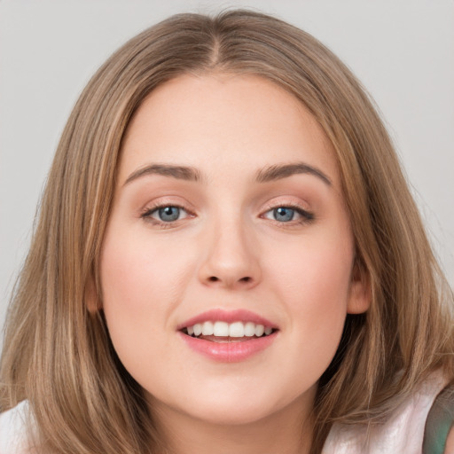 Joyful white young-adult female with long  brown hair and grey eyes