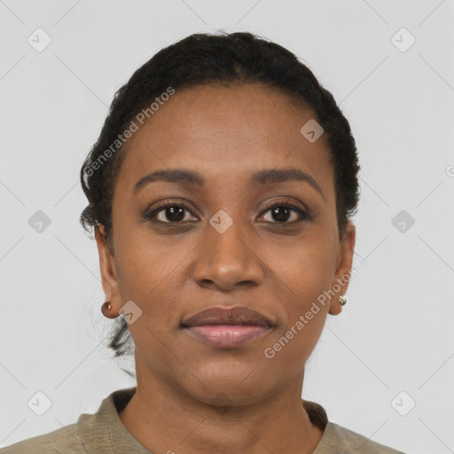 Joyful black young-adult female with short  black hair and brown eyes