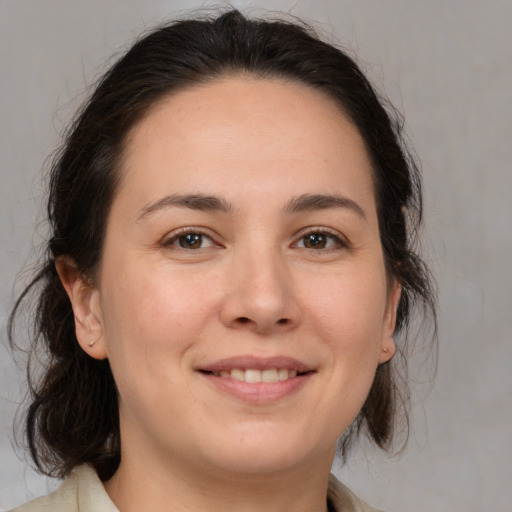 Joyful white young-adult female with medium  brown hair and brown eyes