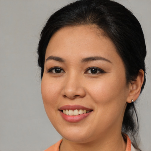 Joyful asian young-adult female with medium  brown hair and brown eyes