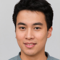 Joyful asian young-adult male with short  black hair and brown eyes