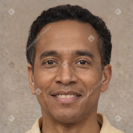 Joyful latino adult male with short  black hair and brown eyes
