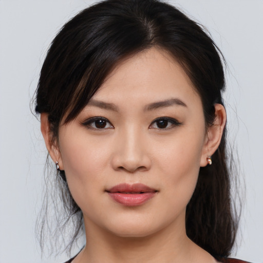 Joyful asian young-adult female with medium  brown hair and brown eyes