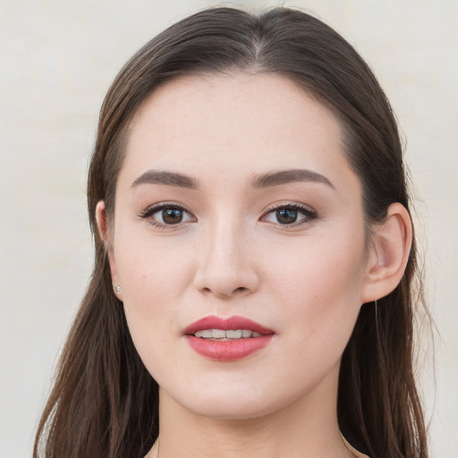 Joyful white young-adult female with long  brown hair and grey eyes