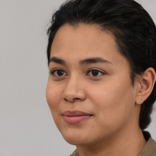 Joyful black young-adult female with medium  black hair and brown eyes