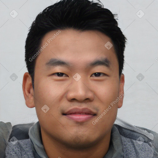 Joyful asian young-adult male with short  black hair and brown eyes