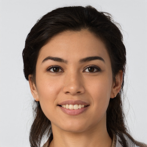 Joyful latino young-adult female with long  brown hair and brown eyes