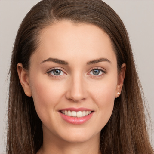 Joyful white young-adult female with long  brown hair and grey eyes